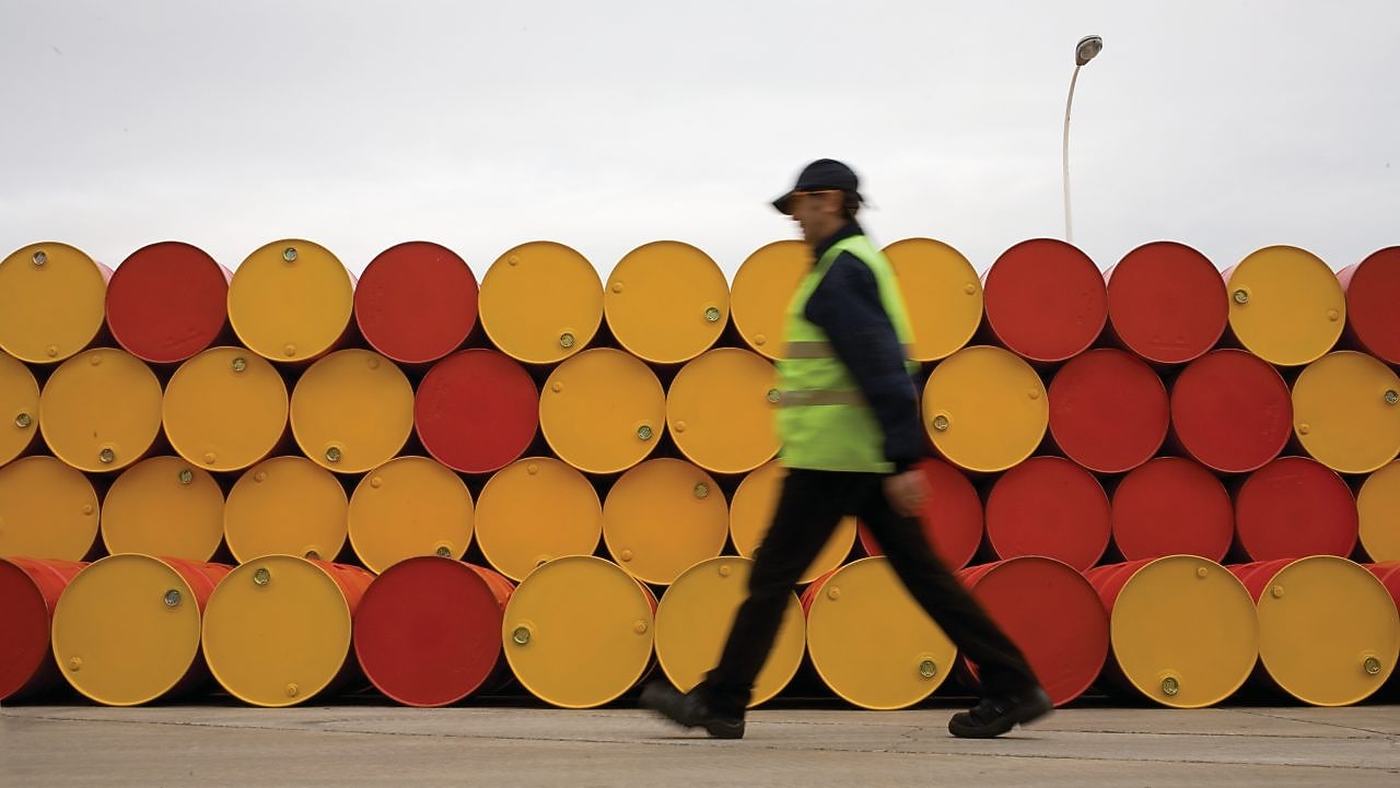 man walking barrels lubricants