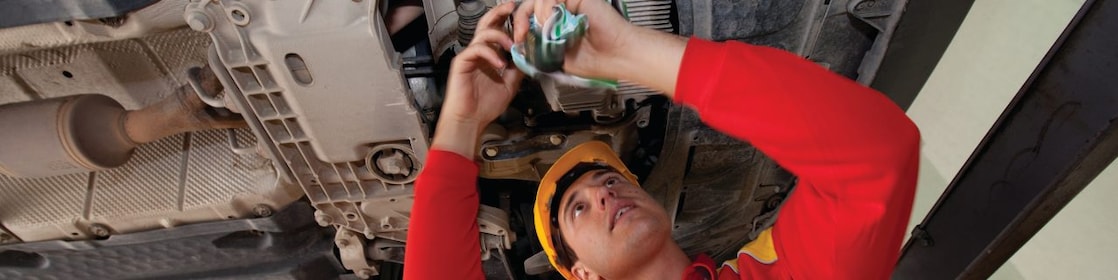 employee doing fitting of parts in car