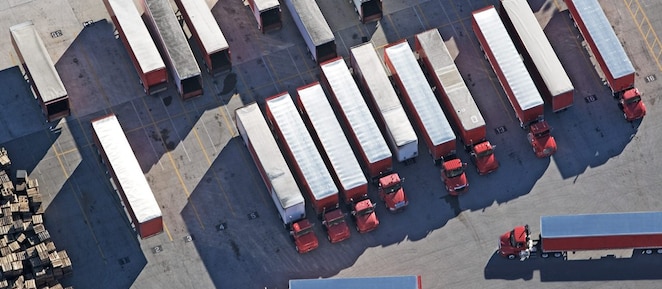 Top down view of red lorries parked in a lorry park