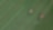 Two tractors in a green field pictured from above