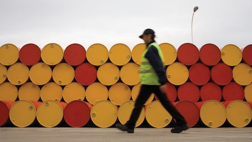 man walking barrels lubricants