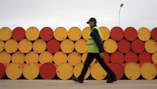 man walking barrels lubricants