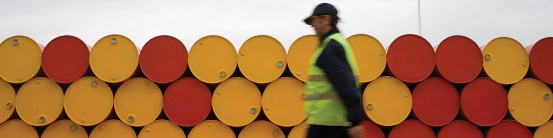 man walking barrels lubricants