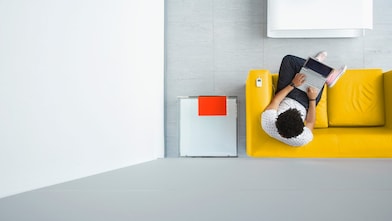 Person relaxing on a sofa in the office