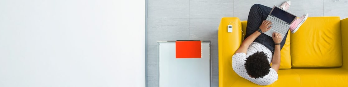Person relaxing on a sofa in the office