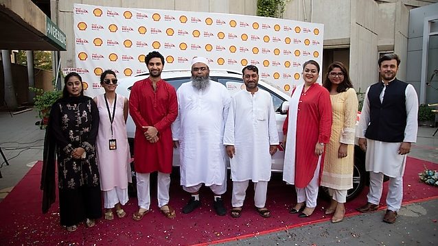 The two winners receive their SUVs from Shell Pakistan representatives as part of a recent promotion for Shell Helix customers.