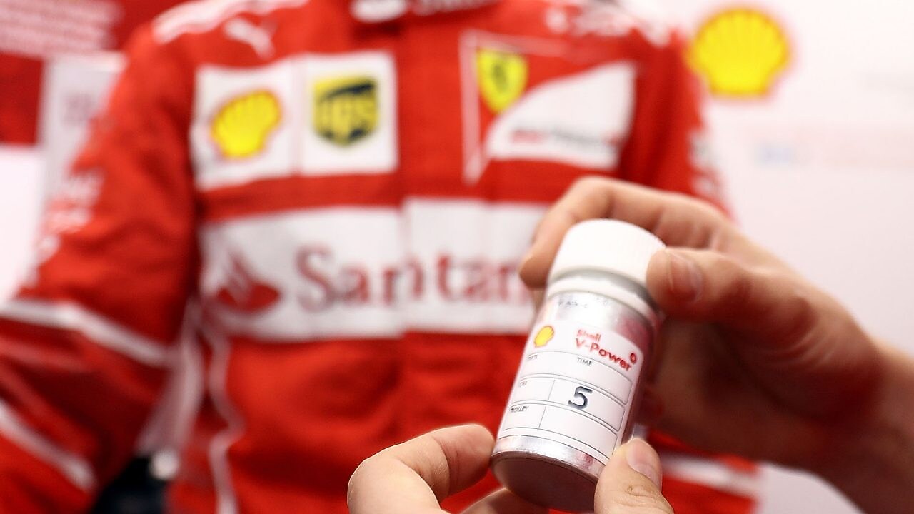 hands holding a V-Power tube on a Shell lab
