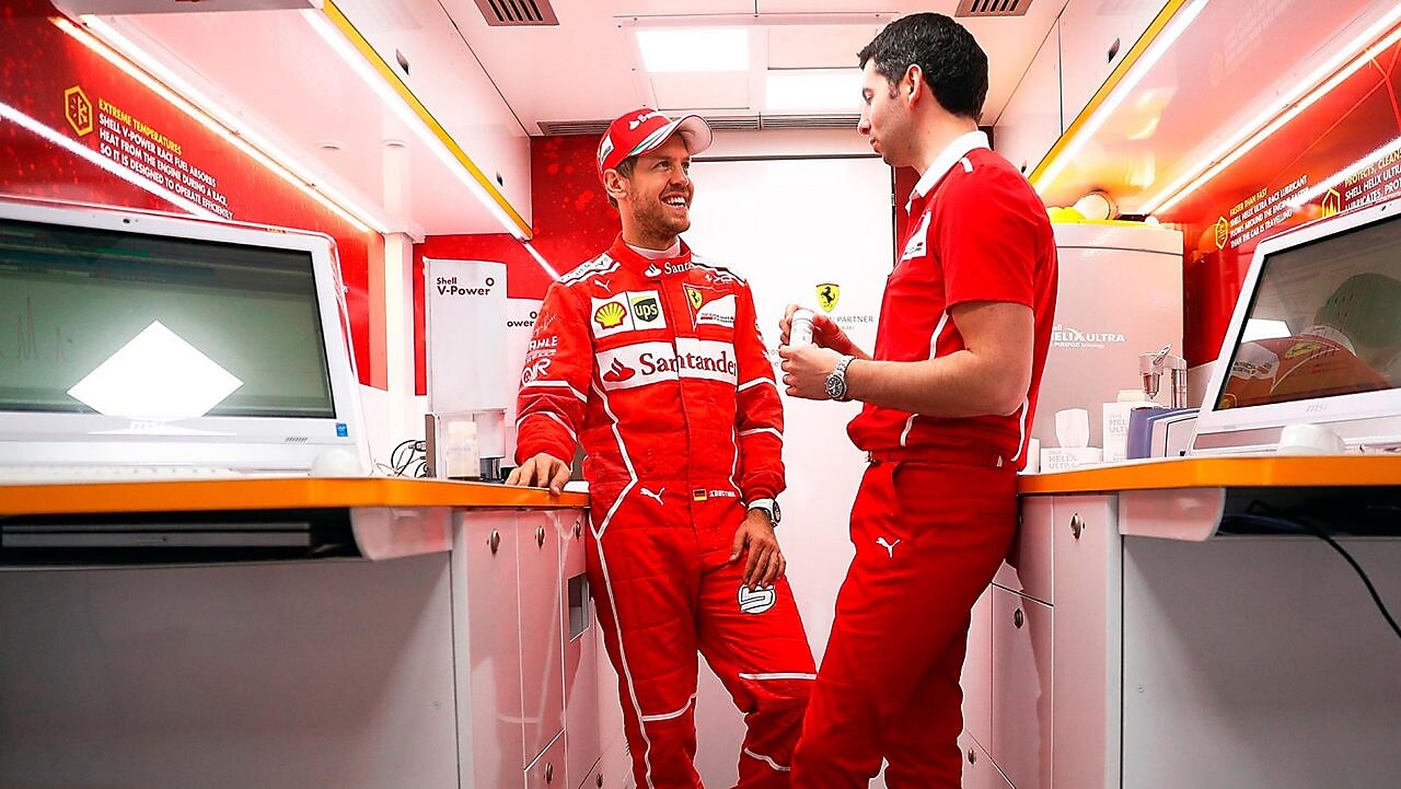 Sebastian Vettel and a Ferrari scientist inside a Shell lab