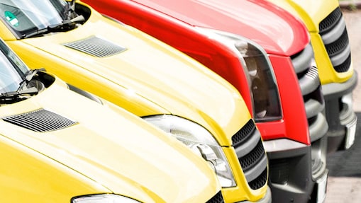 Fleet of yellow and red vans