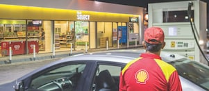 Sun rising behind a Shell station forecourt